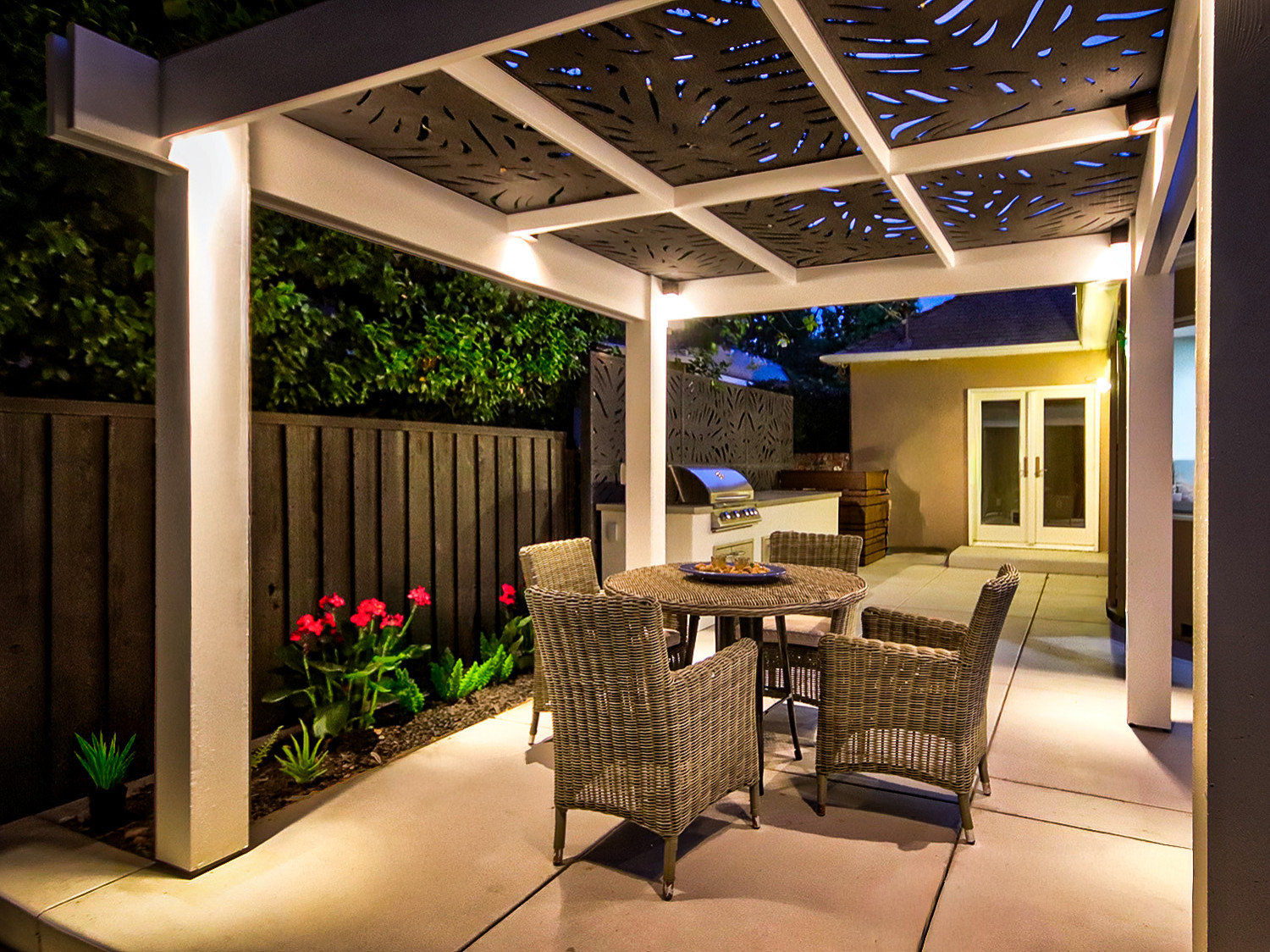 Warm Evening Glow Facing the House: Pergola, Dining, and Outdoor Kitchen