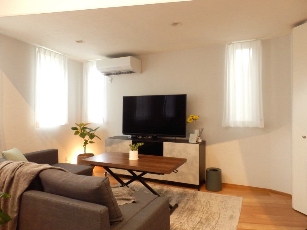 Photo of a small scandi grey and brown open plan living room in Tokyo with white walls, medium hardwood flooring, a freestanding tv, no fireplace and beige floors.