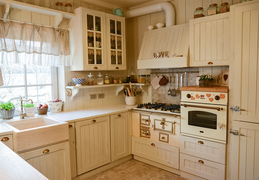 Design ideas for a small traditional u-shaped separate kitchen in Venice with raised-panel cabinets and beige cabinets.
