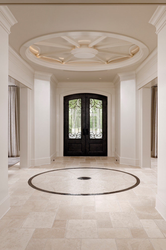 Inspiration for a large transitional limestone floor, beige floor and coffered ceiling front door remodel in DC Metro with white walls and a dark wood front door