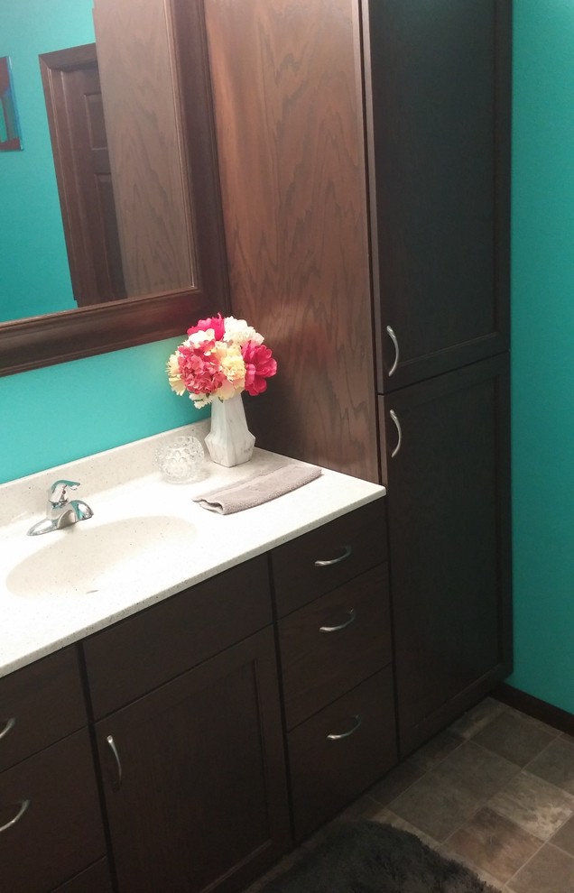 Example of a transitional master home design design with shaker cabinets, blue walls and an integrated sink