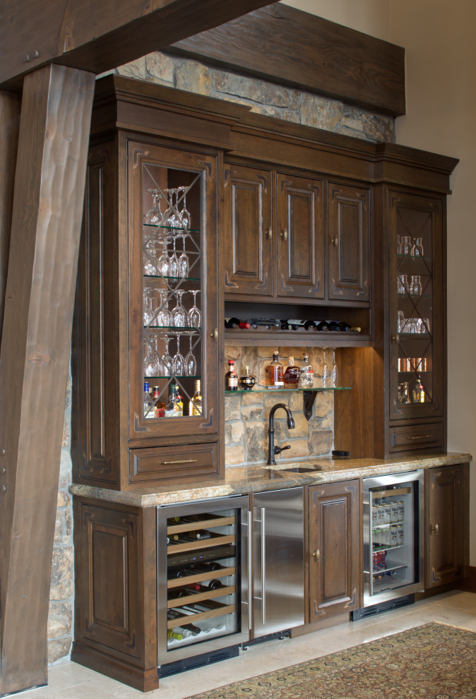 Design ideas for a traditional single-wall wet bar in Denver with an undermount sink, beaded inset cabinets, medium wood cabinets, granite benchtops, beige splashback, limestone floors, white floor and beige benchtop.