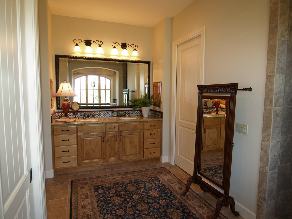 This is an example of a traditional master bathroom in Sacramento with an undermount sink, raised-panel cabinets, medium wood cabinets, granite benchtops, a claw-foot tub, an open shower, a two-piece toilet, brown tile, terra-cotta tile, beige walls and ceramic floors.
