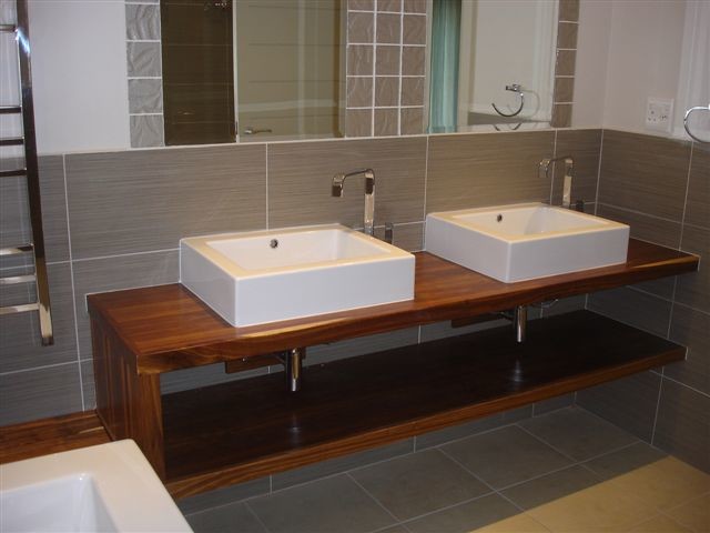 Design ideas for a traditional bathroom in Other with a trough sink, wood benchtops, brown tile, porcelain tile, white walls and porcelain floors.