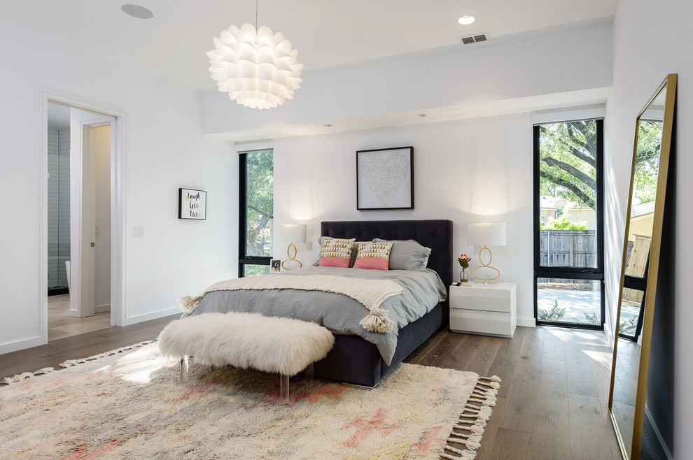 Design ideas for a contemporary master bedroom in Dallas with white walls, dark hardwood floors and brown floor.