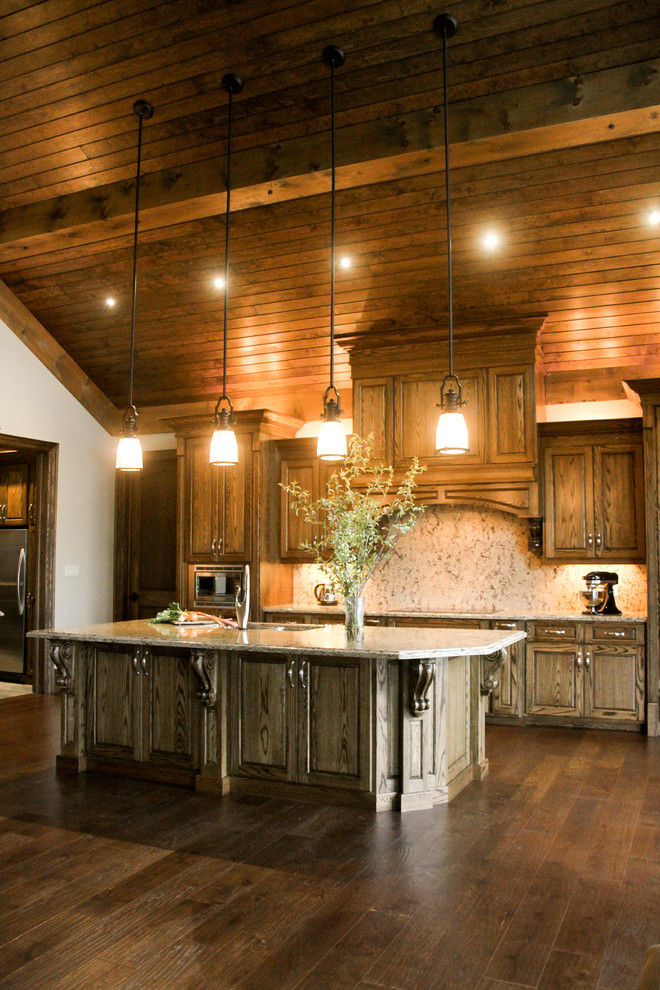 Open concept kitchen - mid-sized rustic l-shaped medium tone wood floor open concept kitchen idea in Toronto with an undermount sink, raised-panel cabinets, medium tone wood cabinets, granite countertops, multicolored backsplash, stone slab backsplash, stainless steel appliances and an island