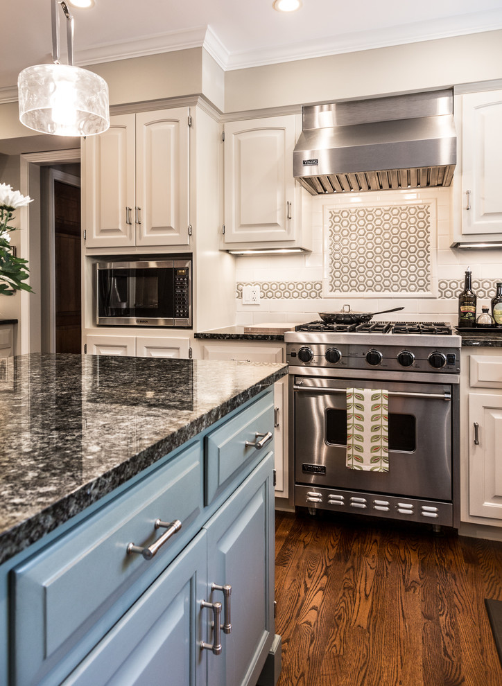 Inspiration for a large transitional u-shaped brown floor and dark wood floor eat-in kitchen remodel in Chicago with an undermount sink, raised-panel cabinets, white cabinets, granite countertops, white backsplash, stainless steel appliances, an island and subway tile backsplash