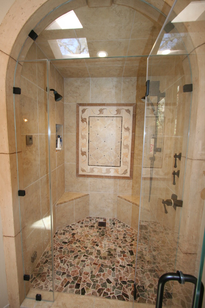 Inspiration for a large traditional master bathroom in San Francisco with a console sink, raised-panel cabinets, dark wood cabinets, marble benchtops, a corner shower, a one-piece toilet, beige tile, stone tile, beige walls and travertine floors.