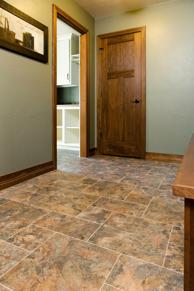 Mid-sized elegant brown floor mudroom photo with green walls