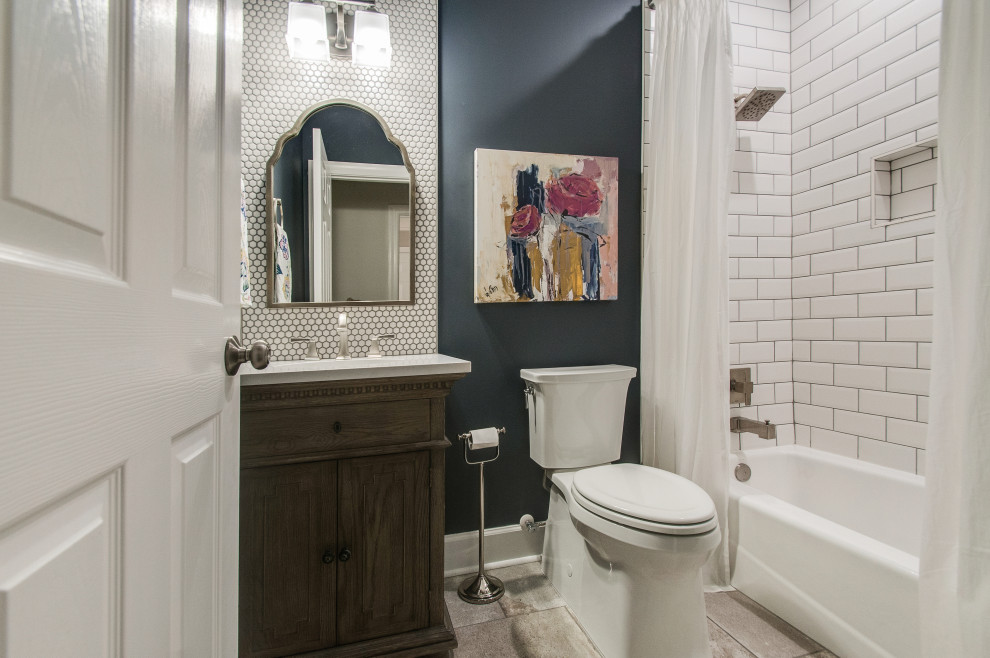 Small transitional powder room in Nashville with distressed cabinets, white tile, ceramic tile, blue walls, ceramic floors, marble benchtops, multi-coloured floor and white benchtops.