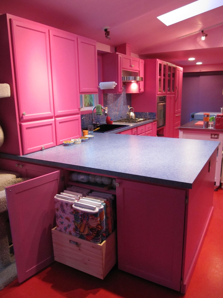 Photo of an eclectic l-shaped eat-in kitchen in Other with a drop-in sink and shaker cabinets.