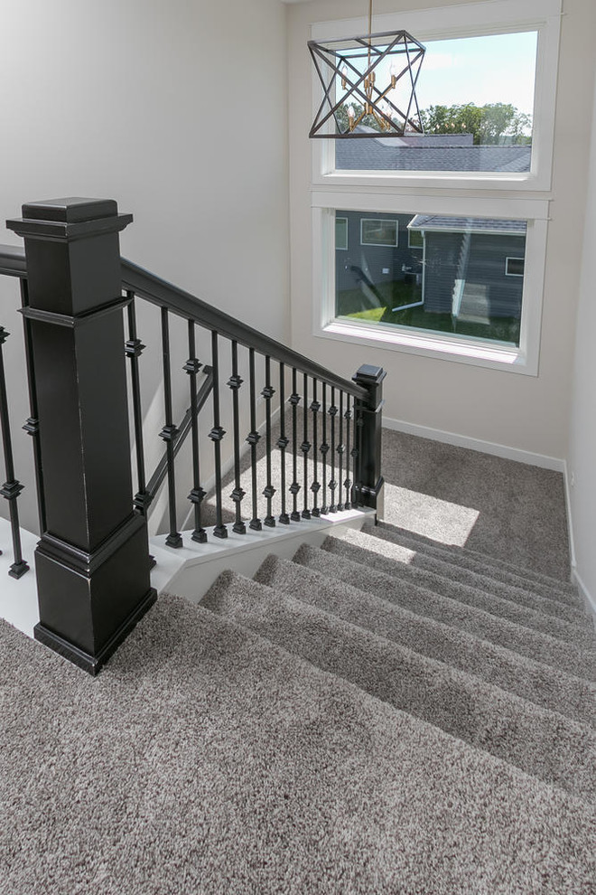 Inspiration for a mid-sized transitional carpeted u-shaped staircase in Minneapolis with carpet risers and mixed railing.
