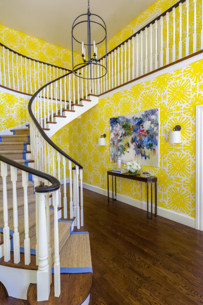This is an example of a large traditional wood curved staircase in San Francisco with painted wood risers and wood railing.