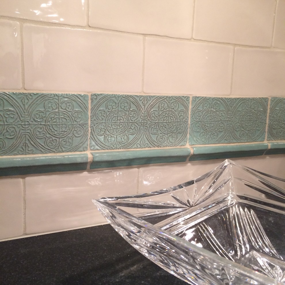Kitchen - mid-sized transitional kitchen idea with yellow backsplash, subway tile backsplash and black countertops
