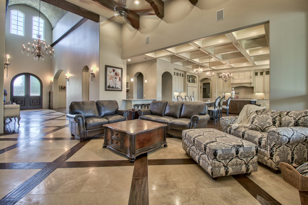 This is an example of a large open concept family room in Phoenix with grey walls, marble floors, a standard fireplace, a stone fireplace surround, a wall-mounted tv and beige floor.