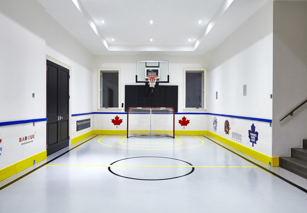 Large modern home gym in Toronto with white walls.