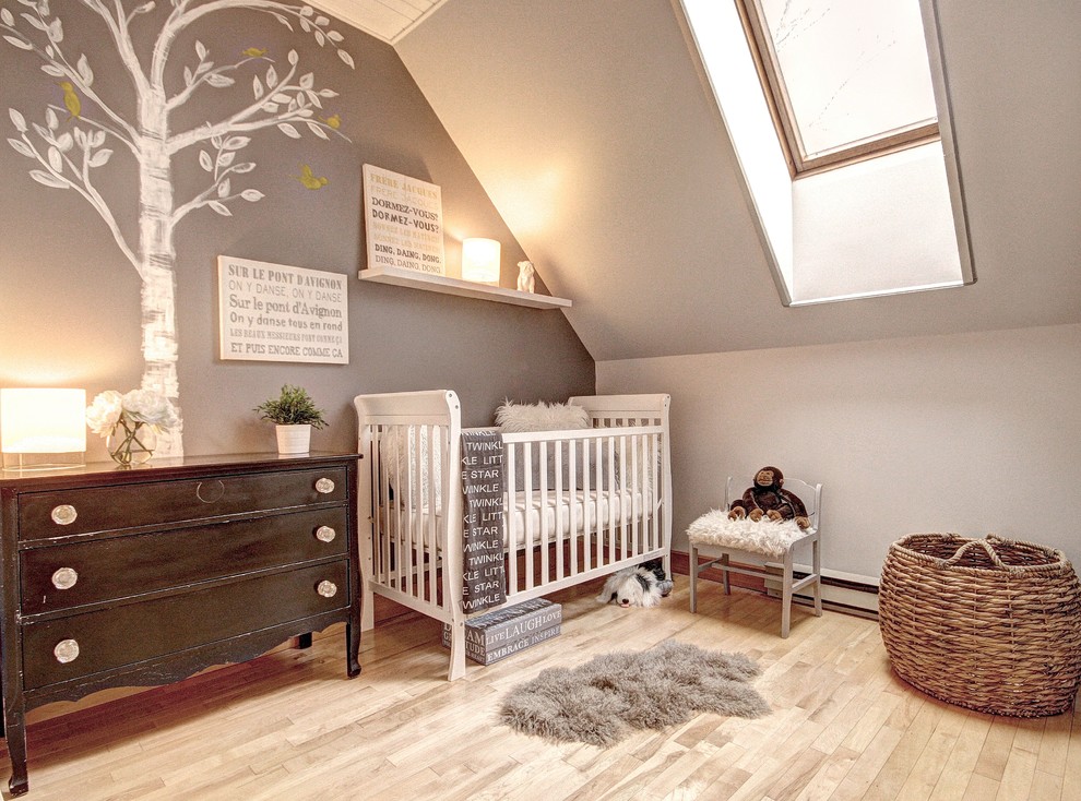 Inspiration for a traditional nursery in Montreal with light hardwood floors.