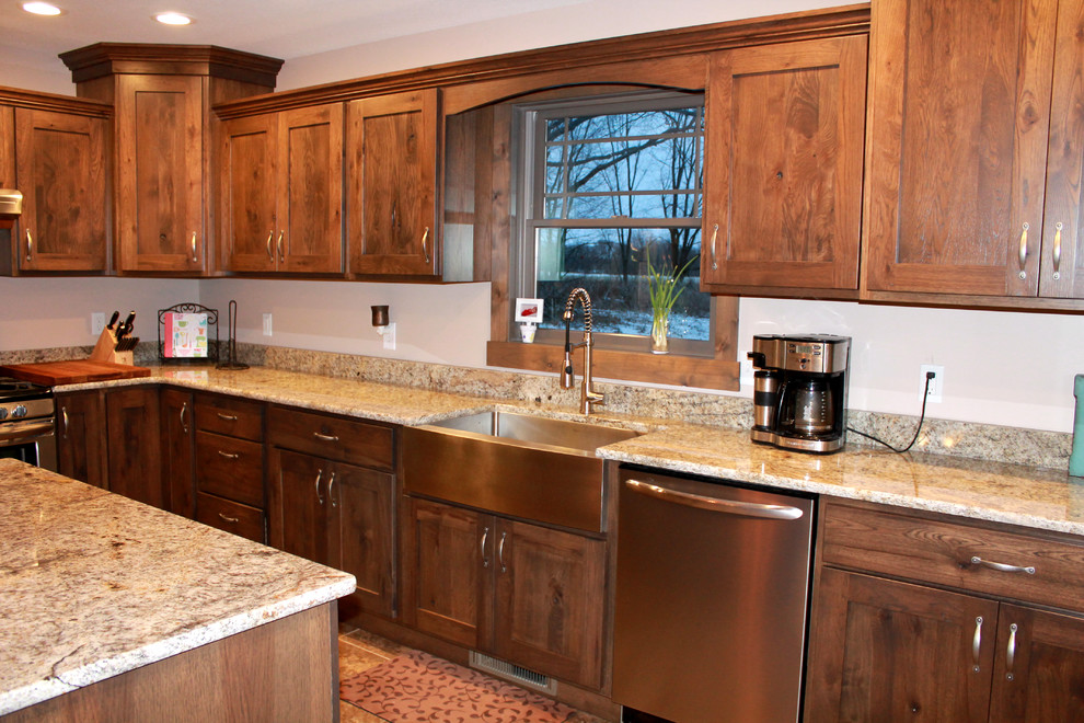 Inspiration for a large rustic l-shaped eat-in kitchen remodel in Chicago with a farmhouse sink, shaker cabinets, dark wood cabinets, granite countertops, stainless steel appliances and an island