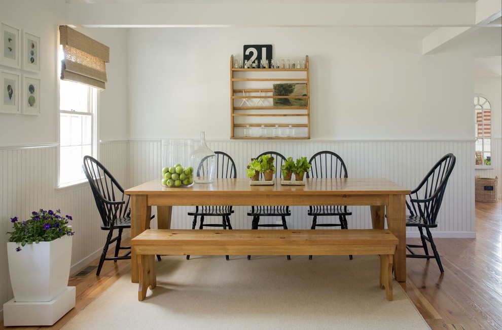 Beach style dining room in Boston with white walls, medium hardwood floors and no fireplace.