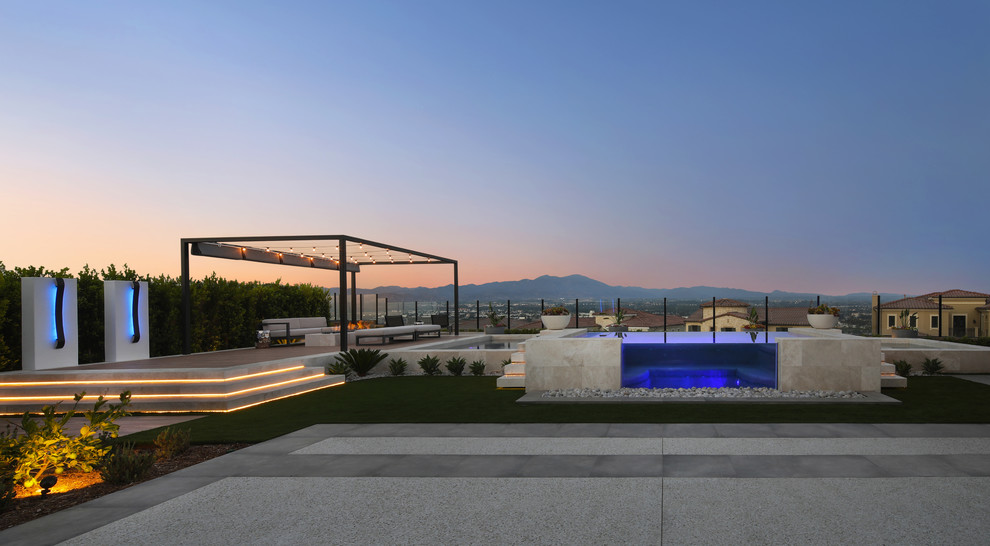Example of a mid-sized transitional backyard custom-shaped natural hot tub design in Orange County