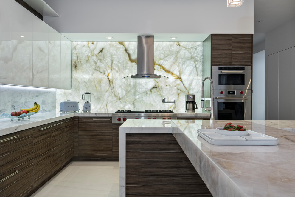 Contemporary l-shaped kitchen in Miami with flat-panel cabinets, dark wood cabinets, white splashback, stone slab splashback, stainless steel appliances, with island, beige floor and white benchtop.