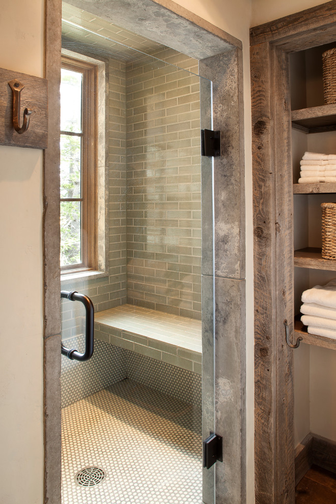 This is an example of a large country master bathroom in Orange County with open cabinets, distressed cabinets, an alcove shower, gray tile, green tile, glass tile, white walls and dark hardwood floors.