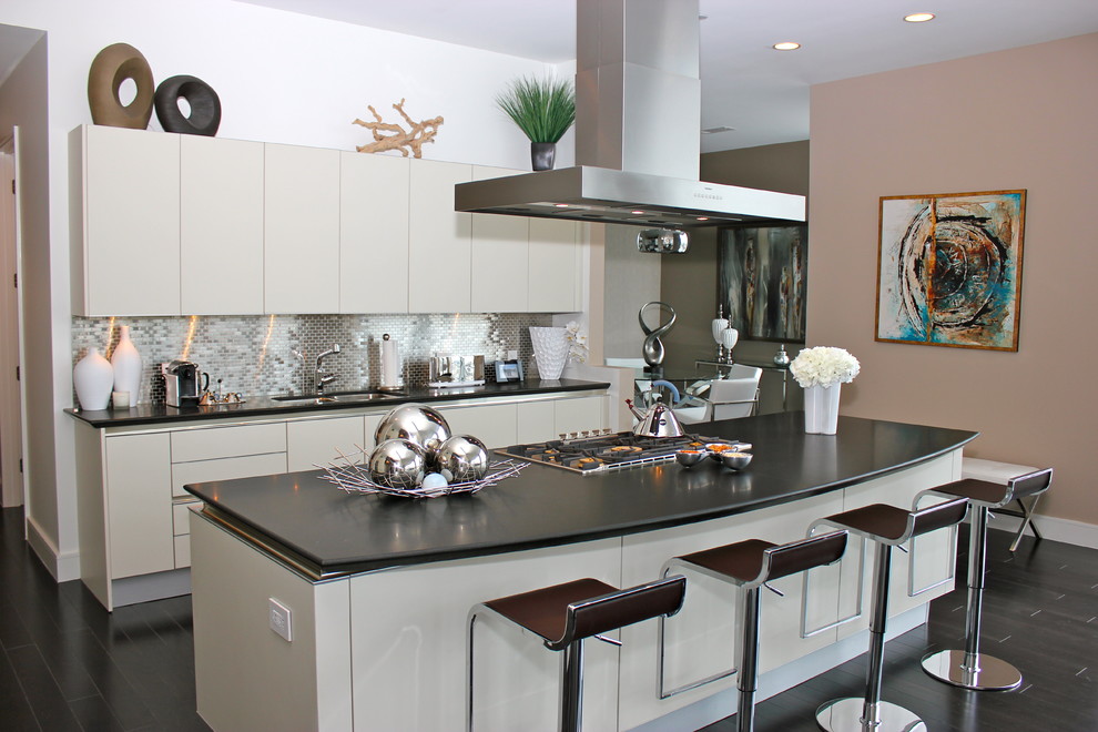 This is an example of a contemporary kitchen in Houston with flat-panel cabinets, grey cabinets, metallic splashback and mosaic tile splashback.