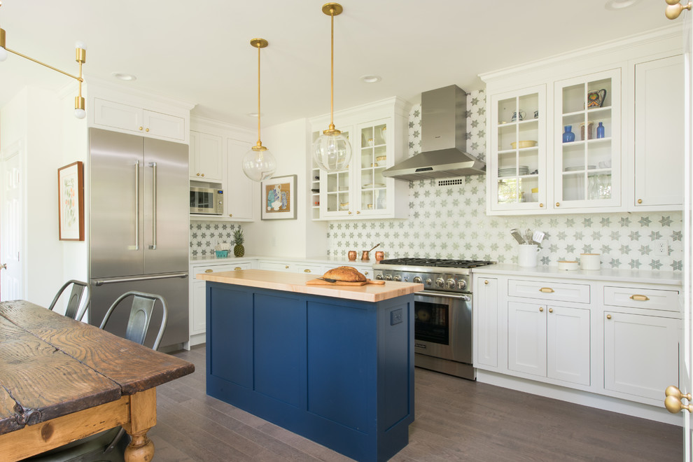 Inspiration for a transitional l-shaped dark wood floor eat-in kitchen remodel in Boston with glass-front cabinets, white cabinets, multicolored backsplash, stainless steel appliances, an island and white countertops