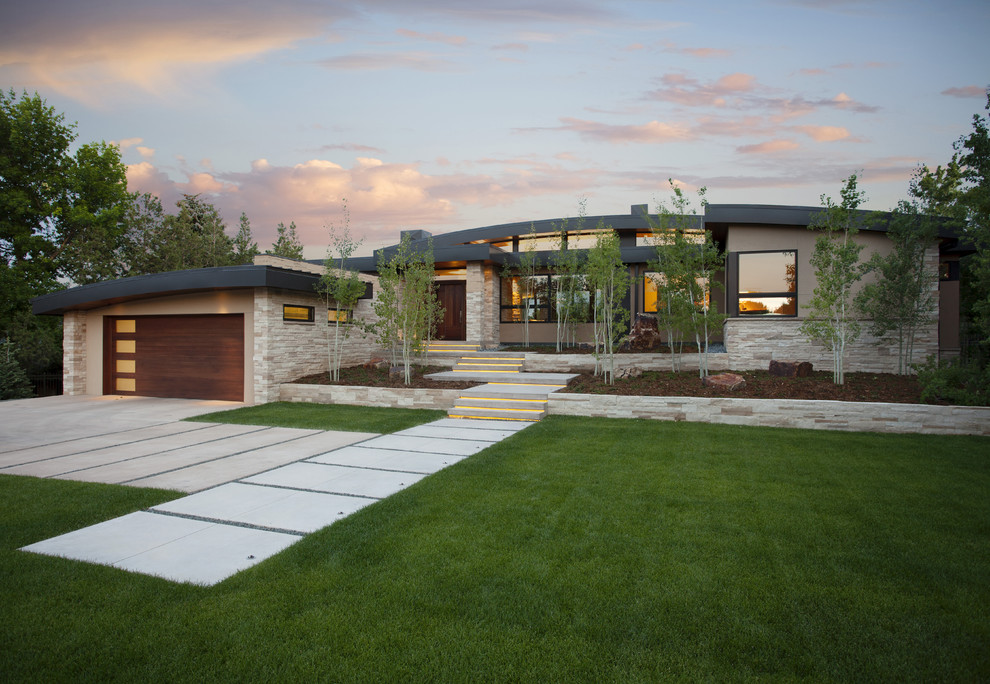 Contemporary two-storey exterior in Denver with stone veneer.