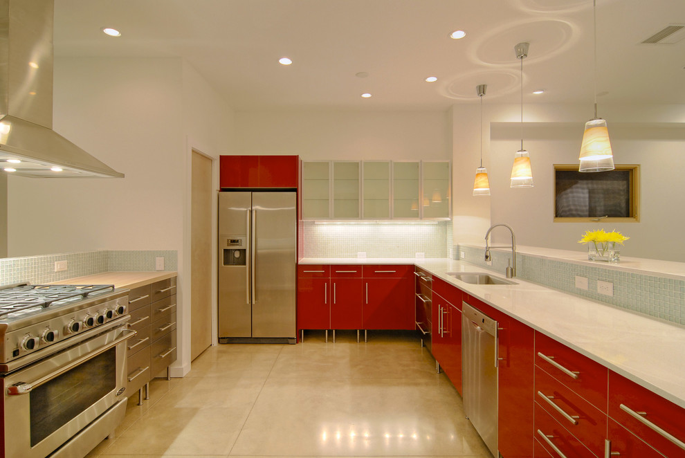 Design ideas for a contemporary u-shaped open plan kitchen in Denver with red cabinets, flat-panel cabinets, an undermount sink, blue splashback, mosaic tile splashback and stainless steel appliances.