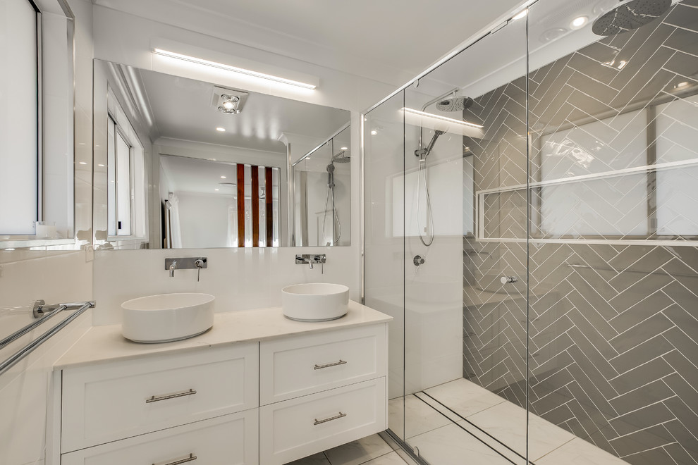 This is an example of a mid-sized transitional master bathroom in Other with white cabinets, multi-coloured tile, multi-coloured walls, a vessel sink, beige floor, a hinged shower door and beige benchtops.