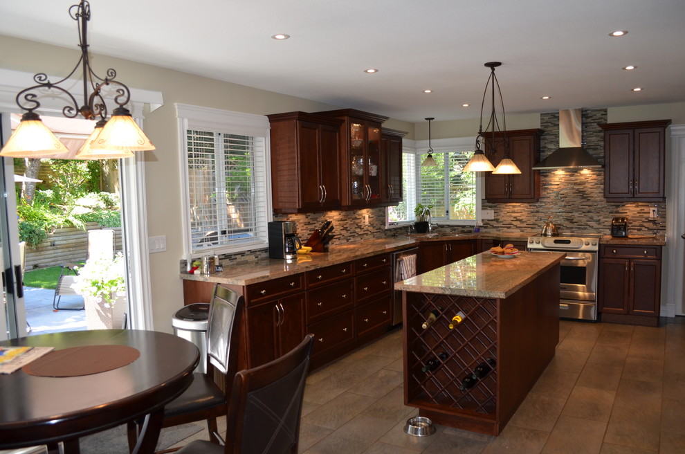 Eat-in kitchen - mid-sized transitional l-shaped porcelain tile and beige floor eat-in kitchen idea in Vancouver with a double-bowl sink, shaker cabinets, dark wood cabinets, granite countertops, beige backsplash, matchstick tile backsplash, stainless steel appliances and an island