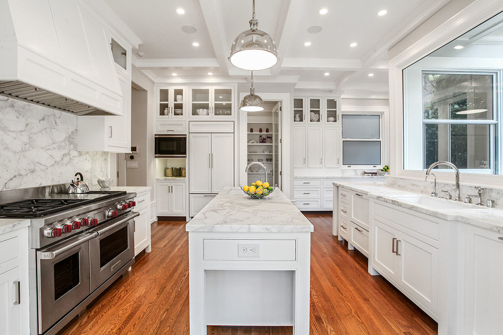 Design ideas for an expansive transitional u-shaped separate kitchen in San Francisco with a single-bowl sink, shaker cabinets, white cabinets, white splashback, stainless steel appliances, medium hardwood floors, with island, marble benchtops and stone slab splashback.