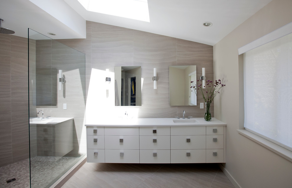 Photo of a large contemporary master bathroom in Vancouver with flat-panel cabinets, white cabinets, beige walls, an undermount sink, engineered quartz benchtops, an open shower, a one-piece toilet, beige tile, porcelain tile and porcelain floors.