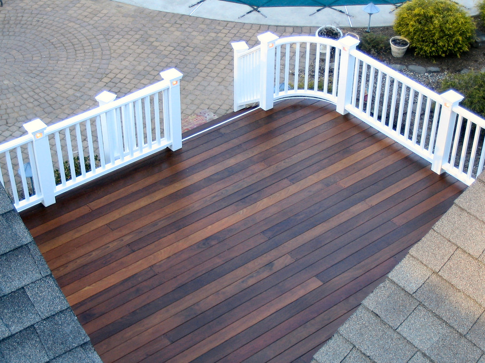 Inspiration for a large traditional backyard deck in New York with a roof extension.