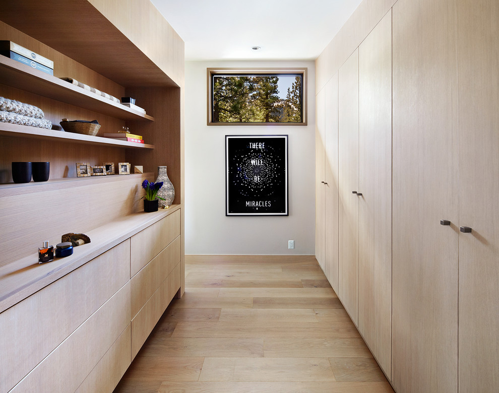 Contemporary storage and wardrobe in San Francisco with medium hardwood floors, flat-panel cabinets, light wood cabinets and beige floor.