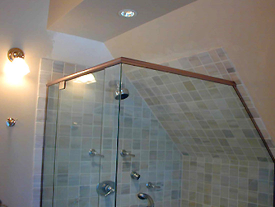Corner shower - mid-sized transitional ceramic tile corner shower idea in Boston with white walls