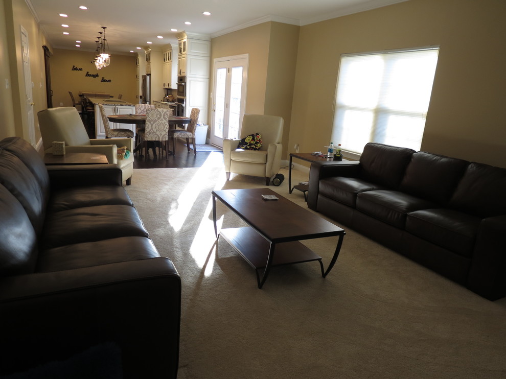 Example of a large transitional galley dark wood floor and brown floor kitchen design with a double-bowl sink, raised-panel cabinets, white cabinets, granite countertops, white backsplash, porcelain backsplash, stainless steel appliances and an island