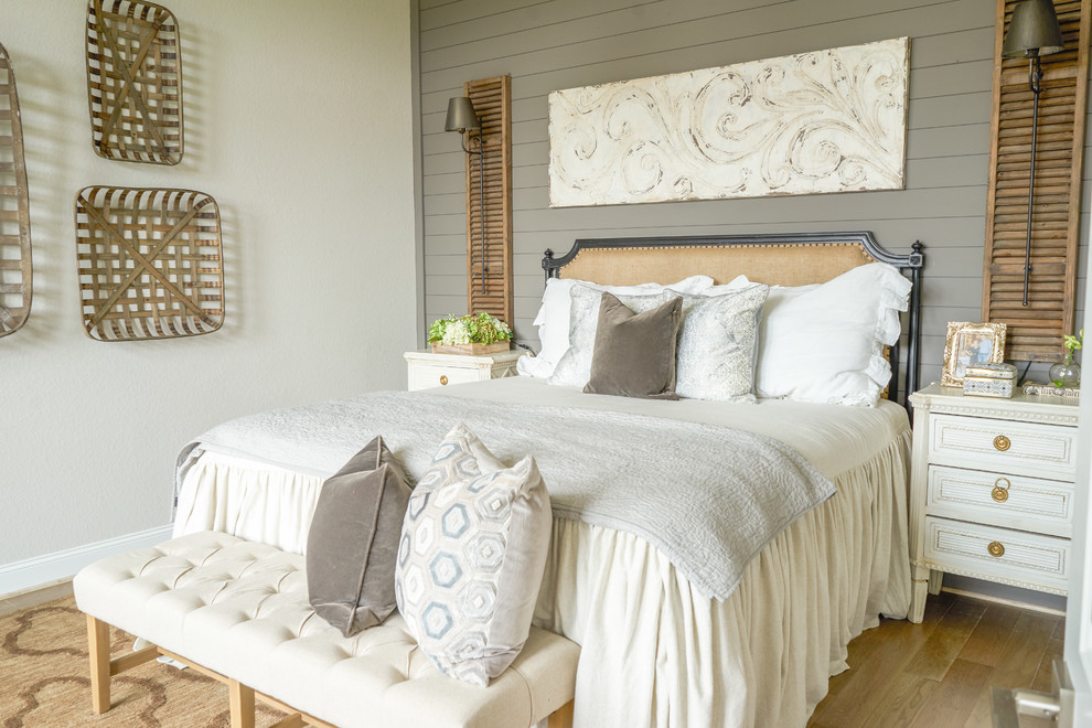 Design ideas for a transitional bedroom in Austin with beige walls, medium hardwood floors and brown floor.