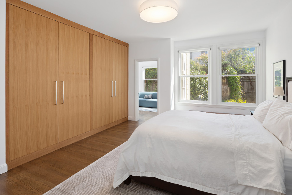 This is an example of a large classic master bedroom in San Francisco with white walls, medium hardwood flooring, brown floors and a wallpapered ceiling.
