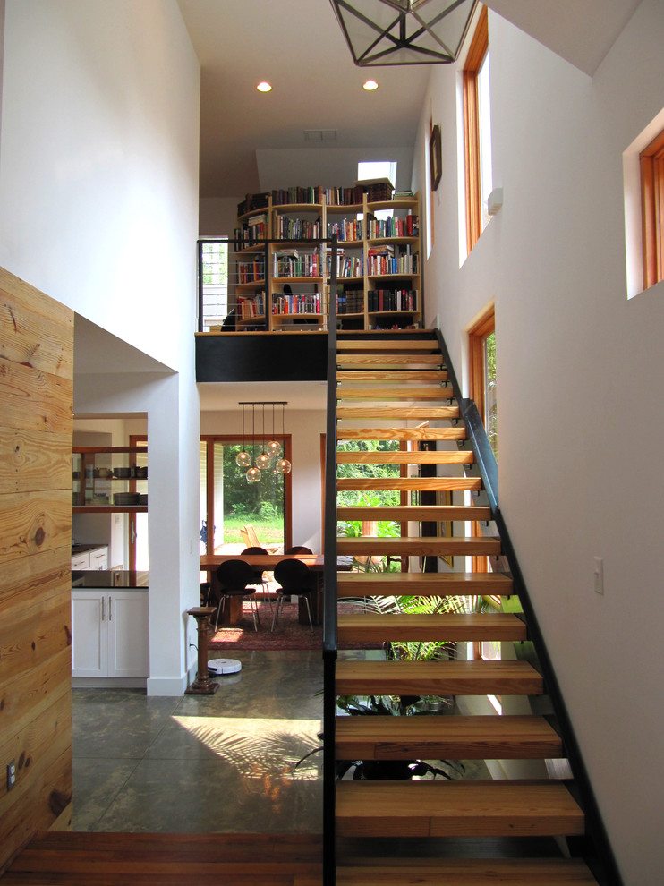 Inspiration for a small industrial wood straight staircase in Atlanta with open risers.