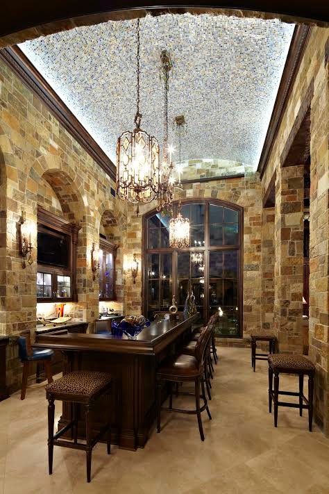 Seated home bar - large rustic single-wall limestone floor seated home bar idea with dark wood cabinets