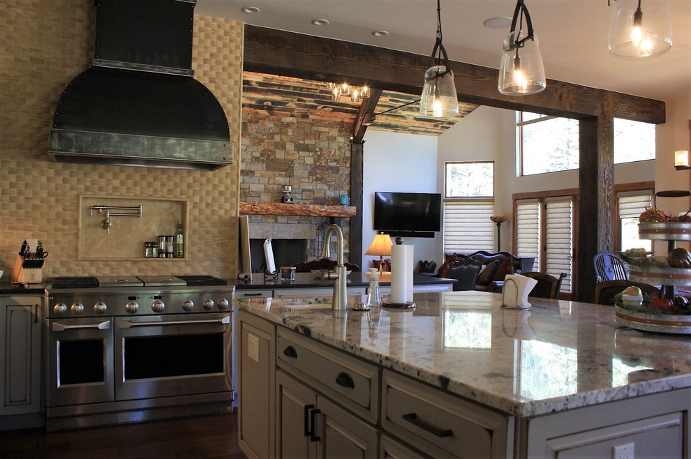 Huge mountain style l-shaped open concept kitchen photo with an undermount sink, quartz countertops, beige backsplash, stone tile backsplash, stainless steel appliances and an island