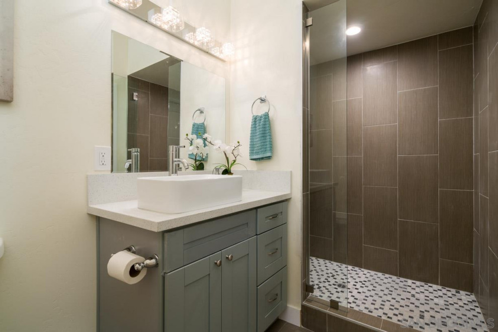 Large modern 3/4 wet room bathroom in San Diego with shaker cabinets, grey cabinets, brown tile, ceramic tile, beige walls, a trough sink, an open shower, white benchtops, a single vanity and a built-in vanity.