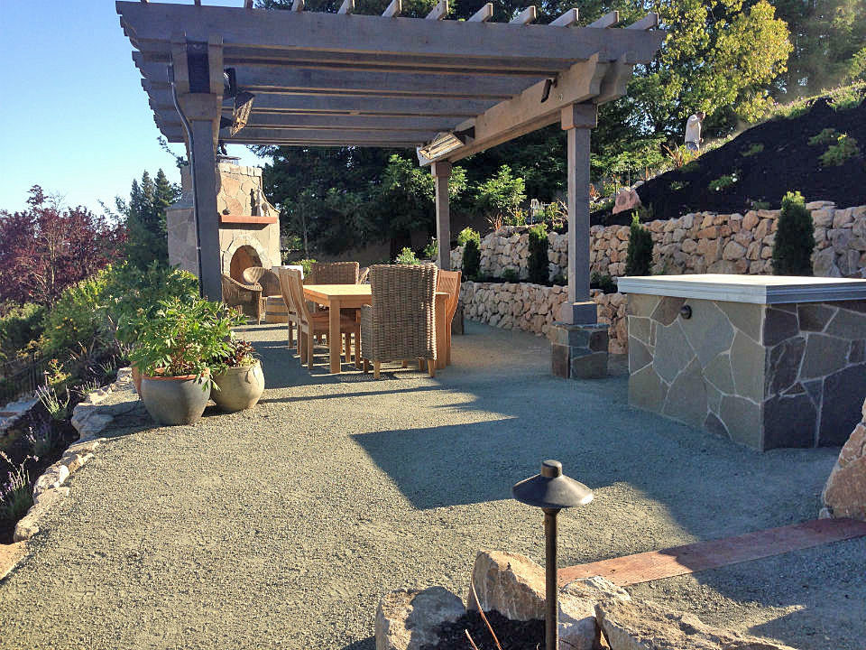 This is an example of an expansive traditional backyard patio in San Francisco with a fire feature, decomposed granite and a pergola.