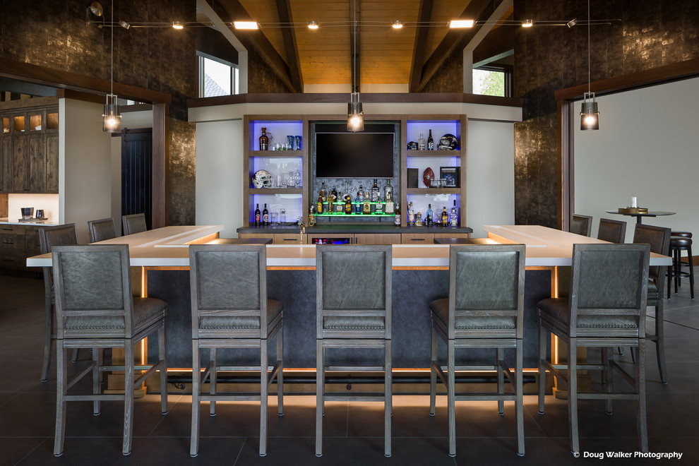 Large contemporary u-shaped seated home bar in Seattle with a drop-in sink, flat-panel cabinets, brown cabinets, concrete benchtops, brown splashback, timber splashback, slate floors, grey floor and white benchtop.