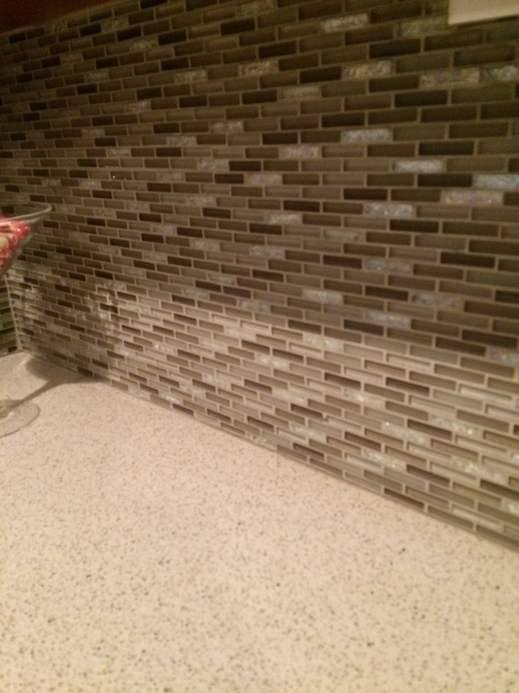 Transitional kitchen photo with granite countertops, brown backsplash and matchstick tile backsplash