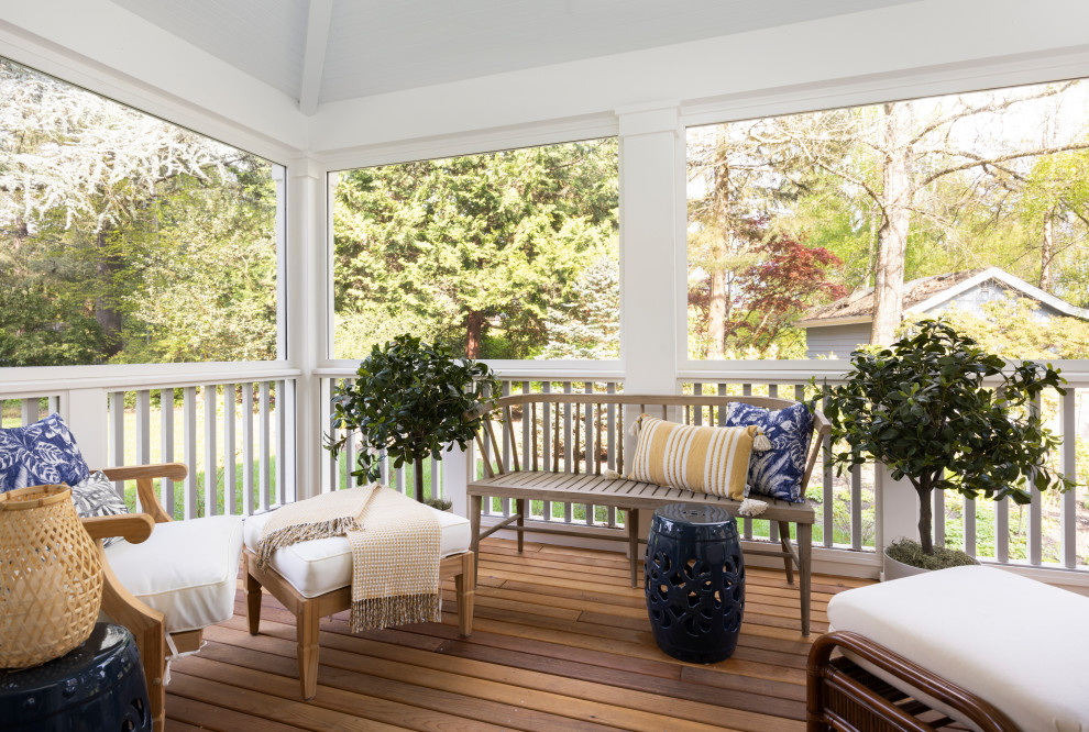 Design ideas for a mid-sized traditional side yard screened-in verandah in Portland with a roof extension and wood railing.