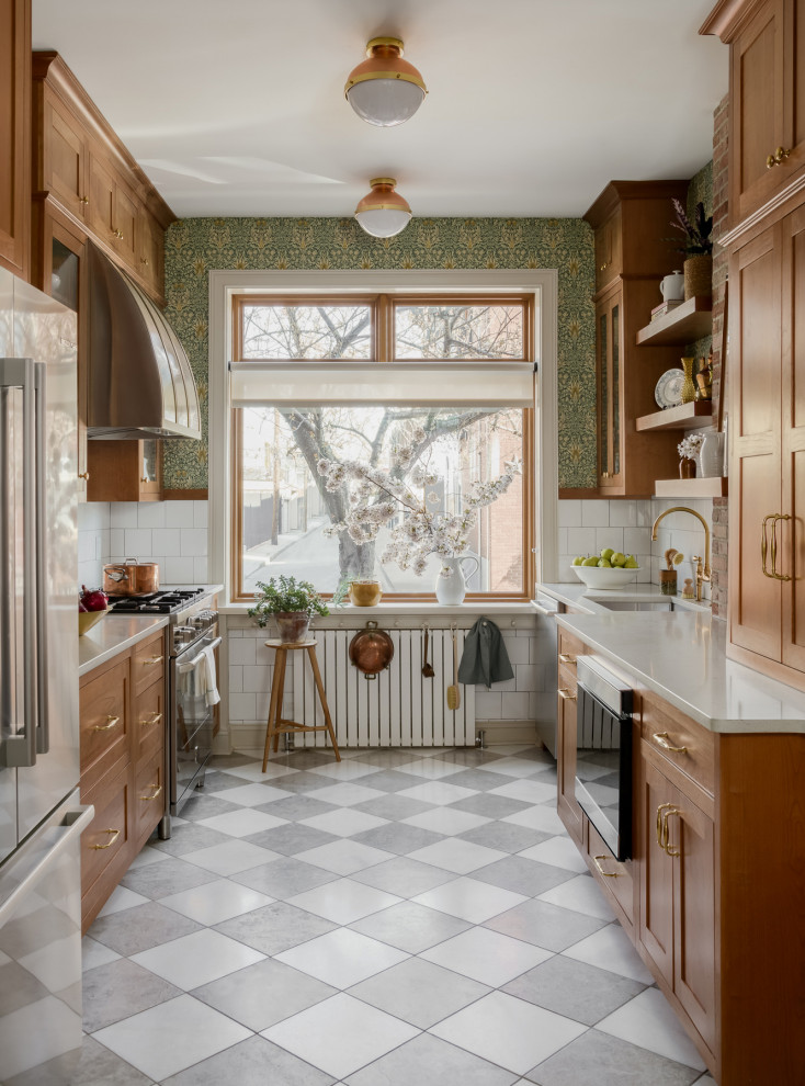 Small traditional galley separate kitchen in Philadelphia with an undermount sink, shaker cabinets, medium wood cabinets, quartz benchtops, white splashback, subway tile splashback, stainless steel appliances, marble floors, no island, grey floor and yellow benchtop.