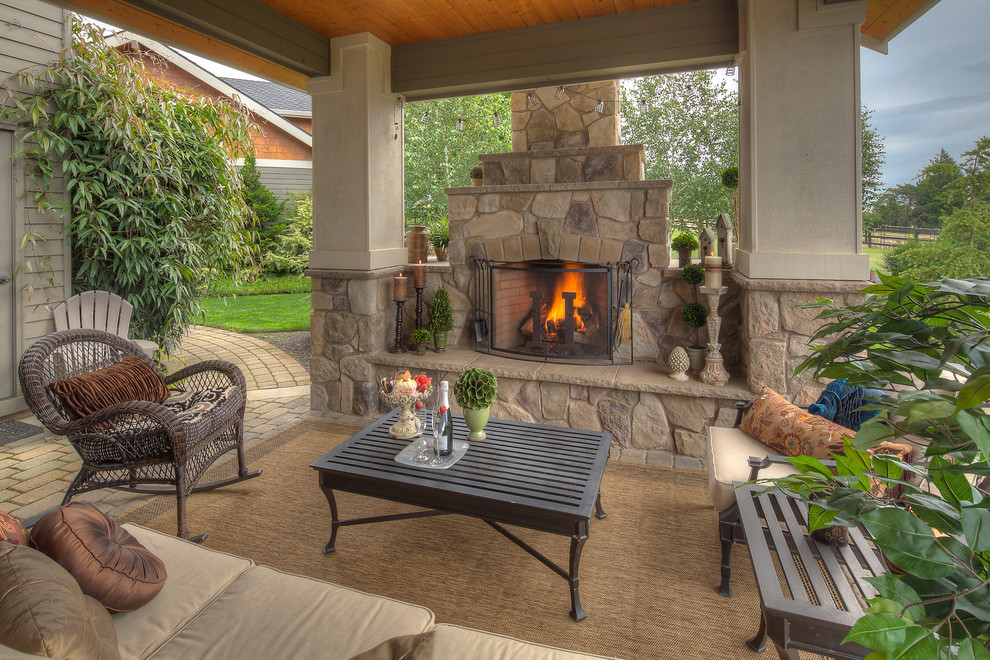 This is an example of a traditional patio in Portland with a fire feature and a pergola.